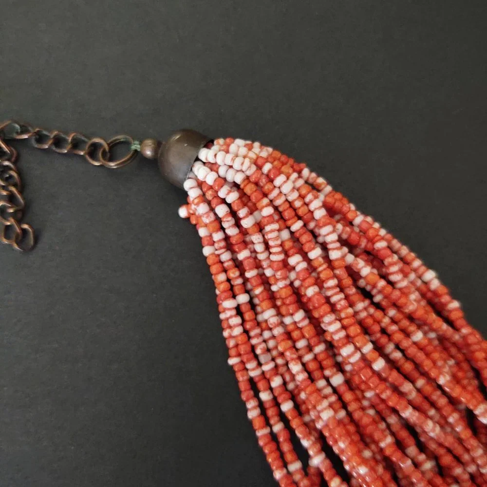 Orange and white multi strand seed bead necklace